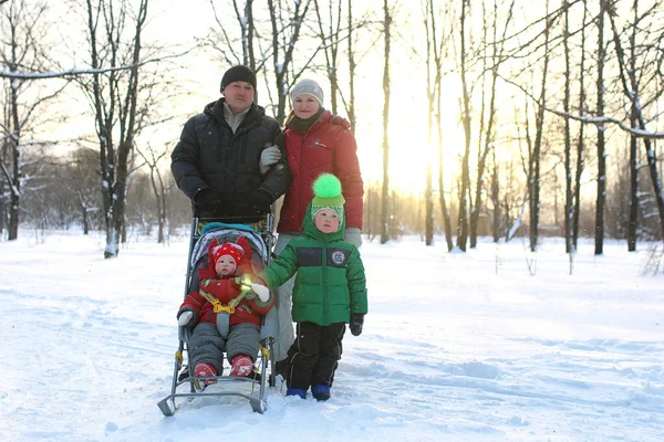 Jonge familie met kinderen in de winter — Stockfoto