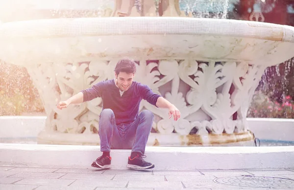 A young man walks in the park at lunch time. A man is on a walk