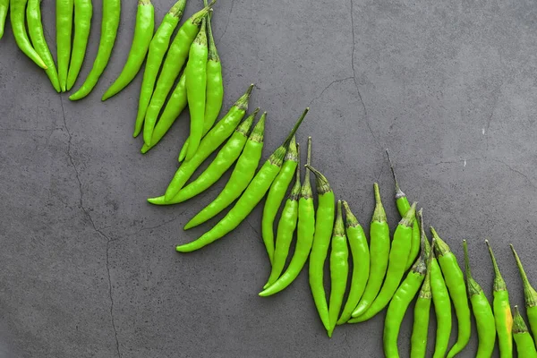 Hot green pepper. Chilean pepper on a black.