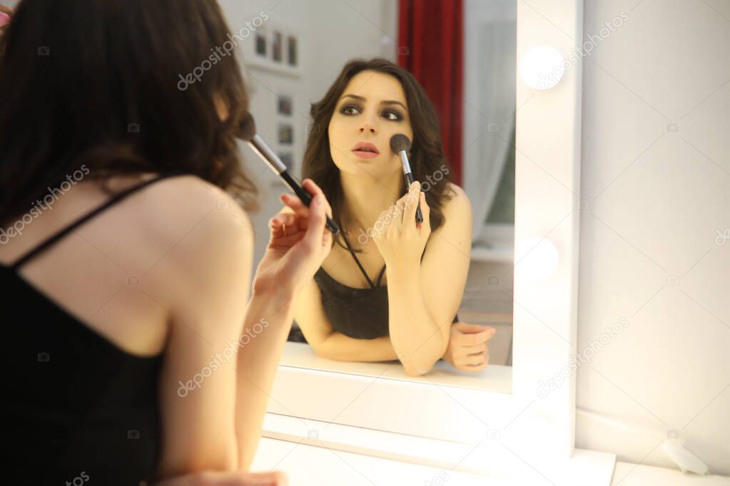 Beautiful girl doing makeup