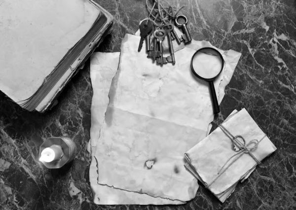 papers and book on detective work table with tools