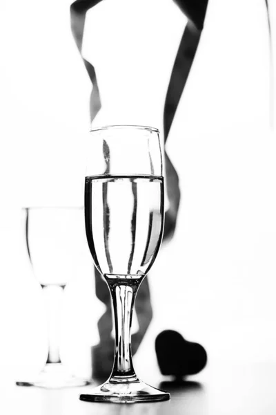 Monochrome photo of champagne on white table on white background — Stock Photo, Image