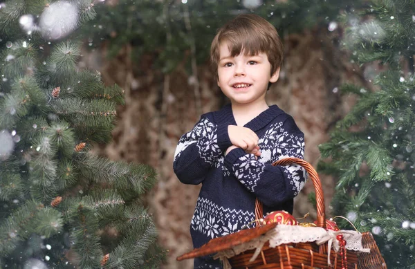 A little child by the New Year tree. Children decorate the Chris — Stock Photo, Image