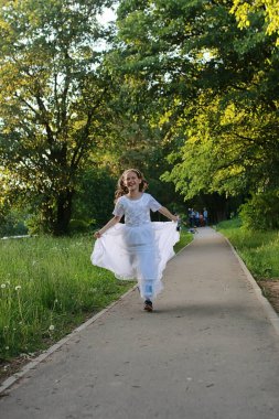 Bir bahar parkta bir karahindiba çiçek tohumlarından üfleme teen