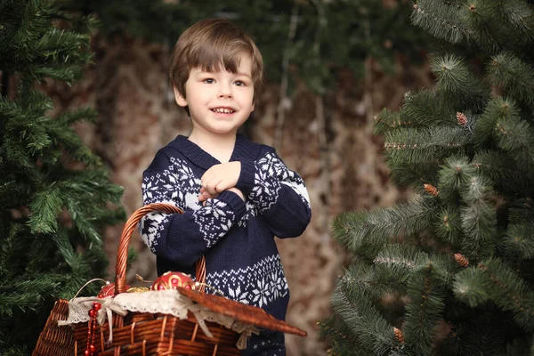 A little child by the New Year tree. Children decorate the Chris — Stock Photo, Image