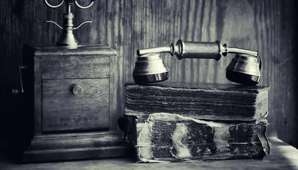 Старый телефон и ретро-книга на столе. Телефон прошлого. — стоковое фото