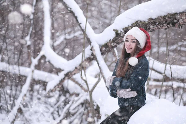 Lány a téli parkban hóesésben — Stock Fotó