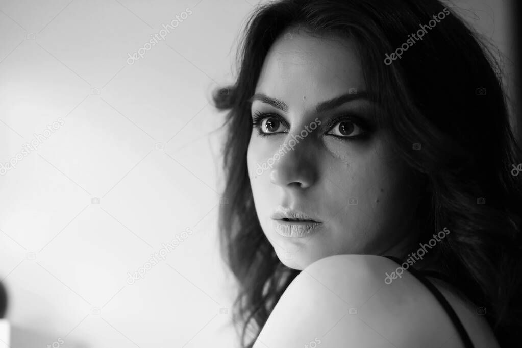 Girl doing makeup black and white