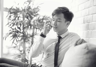 Genç Asyalı işadamı bir kafede bir ortak için bekliyor. Bu