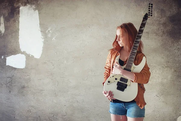 Jonge roodharige meisje met een elektrische gitaar. Rock muzikant gir — Stockfoto