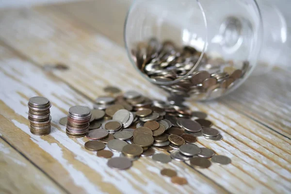 Accumulated coins stacked in glass jars — Stock Photo, Image