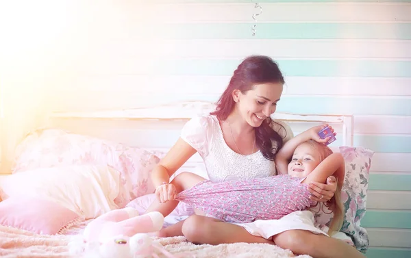 Young girl reads a book Young girl with a daughter are sitting o