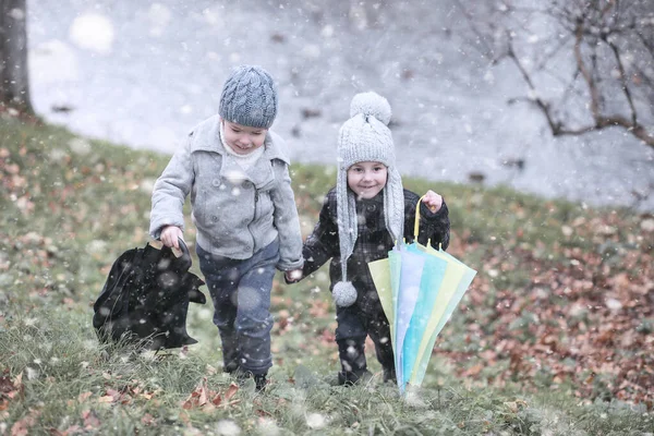 Çocuklar parkta ilk kar yürümek — Stok fotoğraf