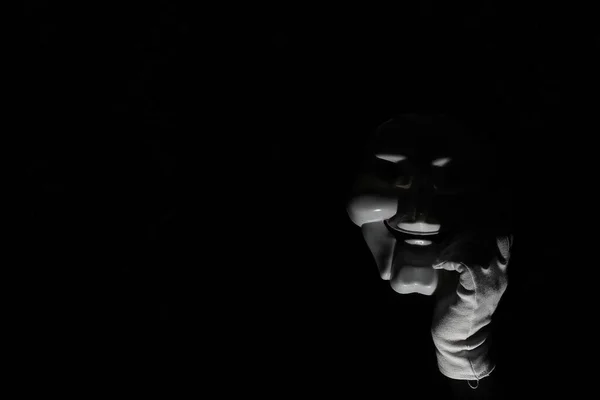 Máscara espeluznante blanca sobre fondo negro con mano blanca . —  Fotos de Stock