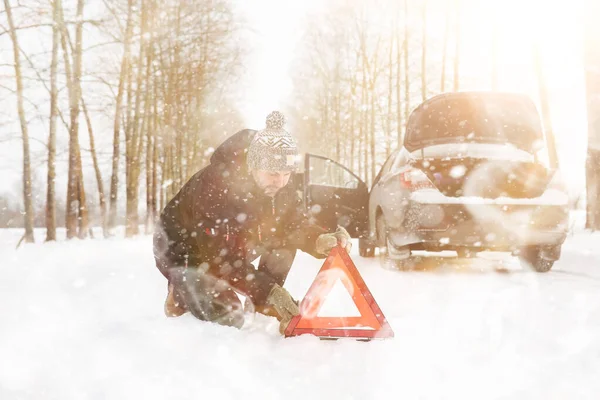 Man and car. Winter walk and car repair. — Stock Photo, Image