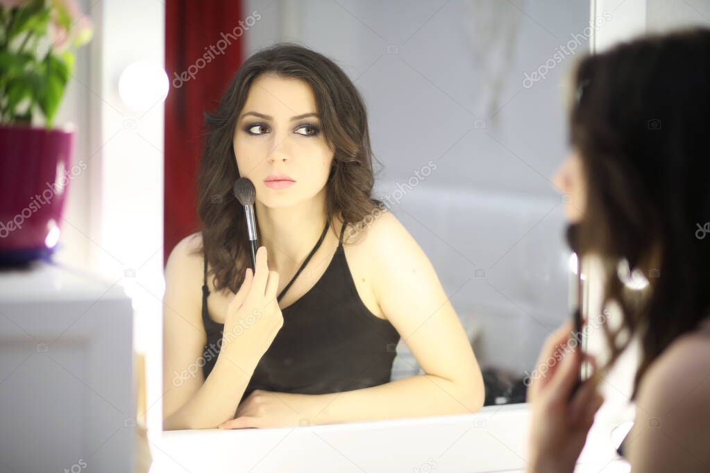 Beautiful girl doing makeup