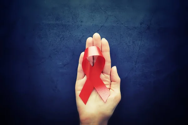 Symbol of human immunodeficiency virus disease. Red ribbon. A he