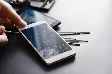 Kırık dokunmatik ekranlı akıllı telefon. Cep telefonu bozuk. Telefon bozuldu. Cep telefonuna kırık cam takmak. Akıllı telefon onarımı.