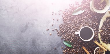 Bir poşet kahve. Kahve çekirdekleri masada kavrulmuş. Pişirmek için yapraklı kahve çekirdekleri.