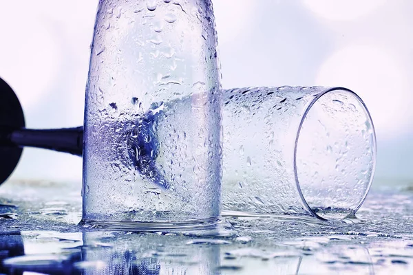 Background with tall glasses for sparkling wines. Champagne spray in glass glasses. Celebratory drink with reflection.