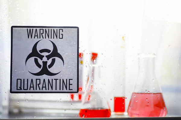 Quarantine. Quarantine warning sign on a glass door in hospital isolator. Isolation of patients with the virus in special laboratories. Virus.