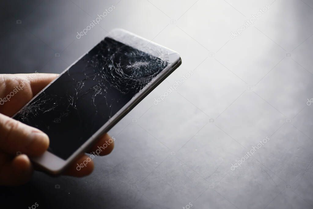 Smartphone with a broken touch screen. Mobile phone broken. The phone crashed. Replacing broken glass on a cell phone. Smartphone repair.