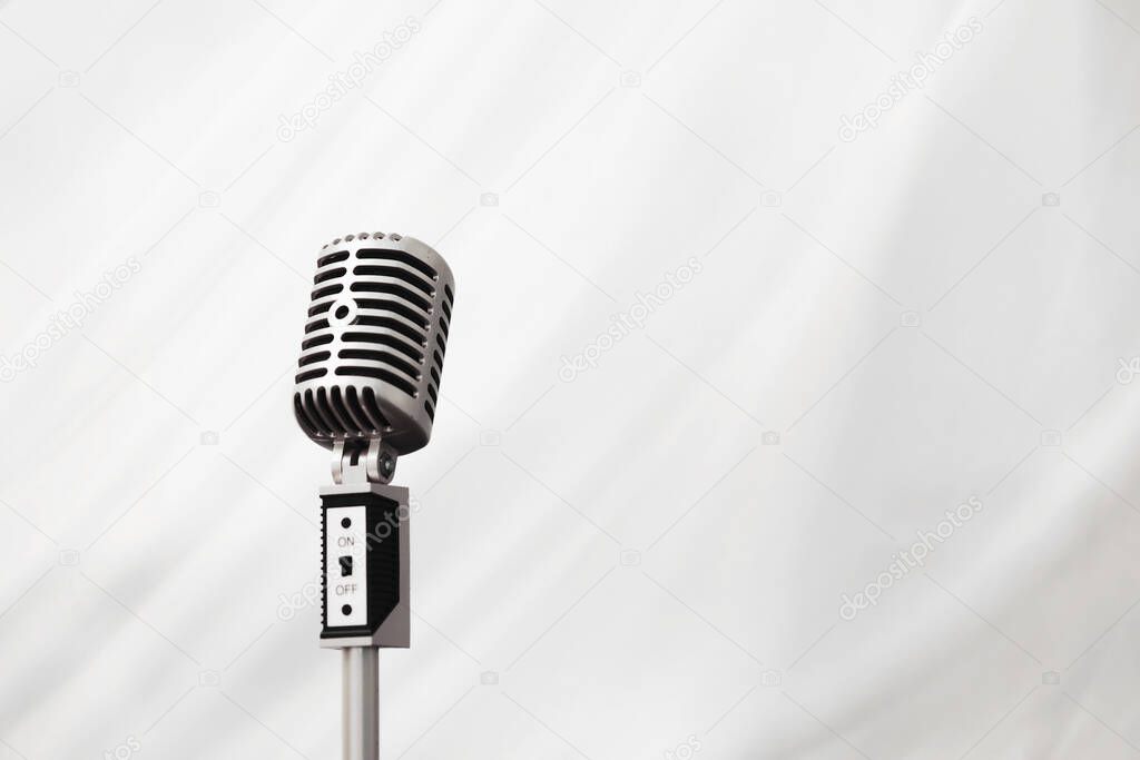 Stand with a retro microphone. Microphone on a tripod. Performance of the artist with vintage microphone. Scene with a microphone.