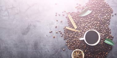 Bir poşet kahve. Kahve çekirdekleri masada kavrulmuş. Pişirmek için yapraklı kahve çekirdekleri.