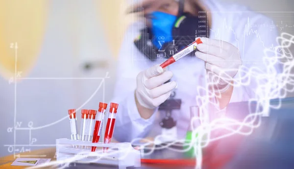 A scientist researcher in the laboratory is testing drugs for treatment of viral pneumonia. Coronovirus blood test of infected patients. World pandemic.