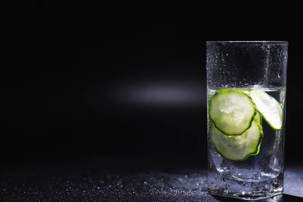 Cucumber water. Drinking water with fresh cucumber. Mineral water. Healthy mineral refreshing water with cucumber.