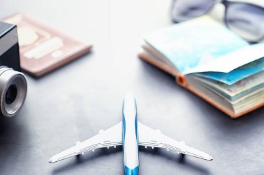 Seyahat konsepti. Turist aksesuarları uçuşta toplanıyor. Alkol, kamera, harita ögeleri.