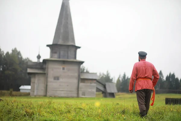 Traditional Slavic rituals in the rustic style. Outdoor in summer. Slavic village farm. Peasants in elegant robes.