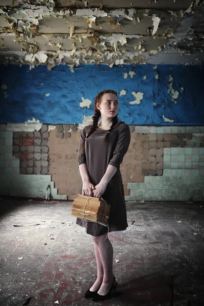 A young girl with old books in the old hous