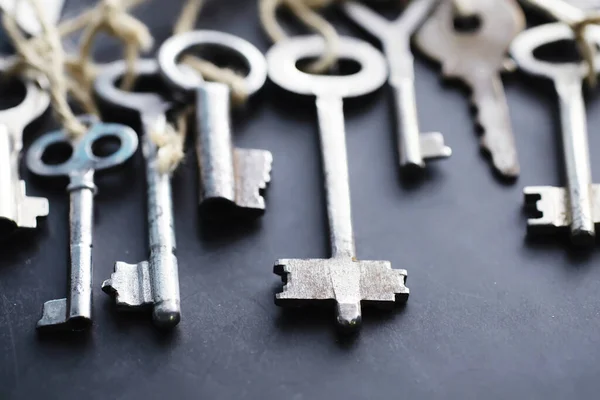 Set of vintage keys for lock. Retro keys on a dark stone background. The concept of choosing the path to achieve the goal.