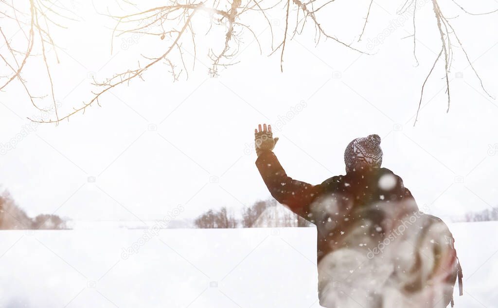 A man on a walk. Winter landscape. Tourist in the winter journey.