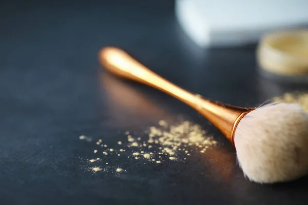 Powder and makeup brush. Brown powder on background. Makeup products. Style concept.