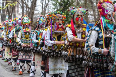 People in traditional carnival kuker costumes at Kukeri festival kukerlandia Yambol, Bulgaria clipart