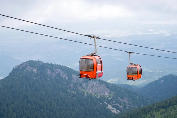 Red cable cabin. Gondola lift in mountain.