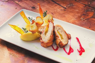 Fırında tavuk mantar ve kırmızı biber ile kahverengi plaka üzerinde rulo