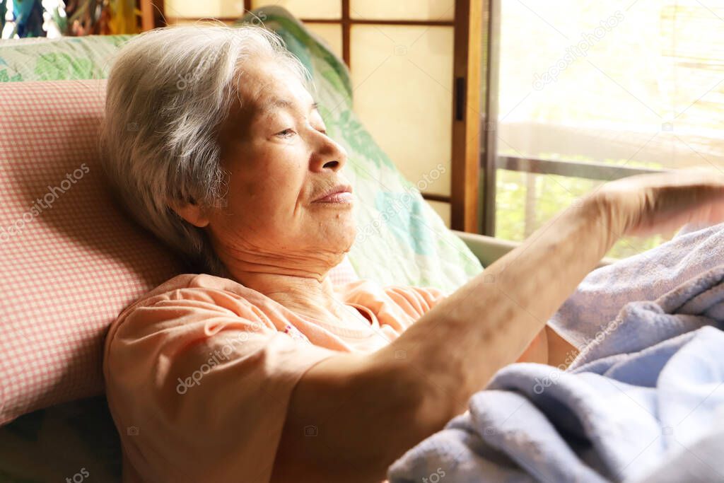 Senior woman relaxing in a nursing bed