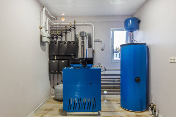 Gas Boiler room in a private house.  Heating system with hot water thermal storage tank