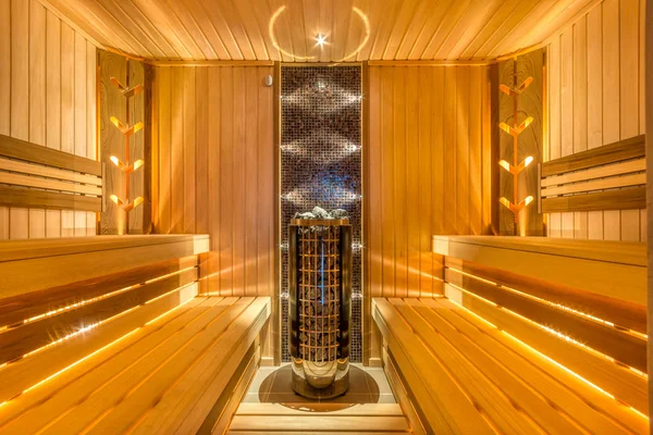 Perfect sauna with electric heater, wood panel walls and beautiful lighting