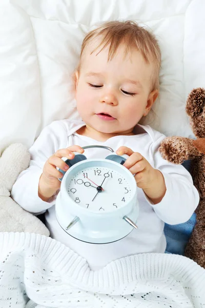 One year old baby with alarm clock — Stock Photo, Image