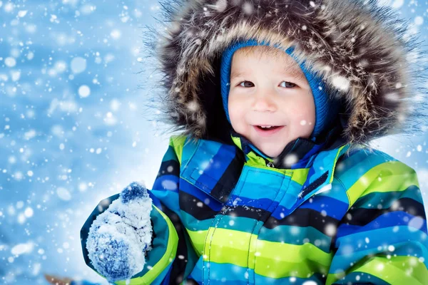 Garçon en bonnet tricoté, gants et écharpe à l'extérieur à la neige — Photo
