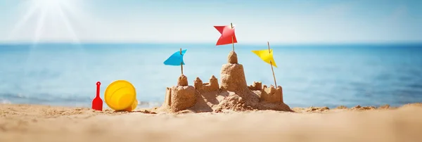 Sandcastle on the sea in summertime — Stock Photo, Image