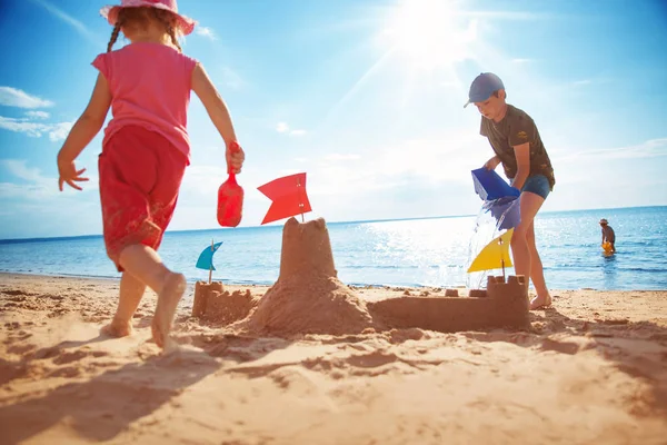 Chłopiec i dziewczyna bawią się na plaży — Zdjęcie stockowe