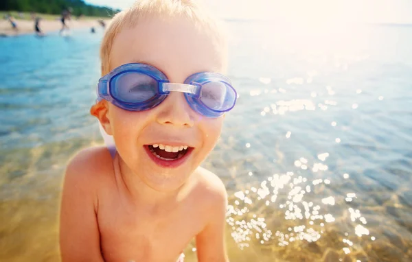 Niño de cuatro años jugando en la playa con gafas de natación — Foto de Stock