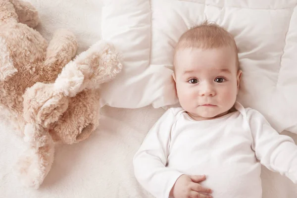 Seven month old baby in the bed — Stock Photo, Image
