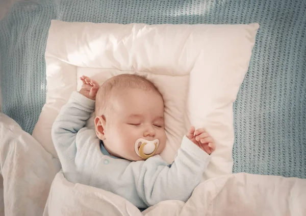 부드러운 흰색 담요로 덮인 채 잠 자고 있는 아기 — 스톡 사진