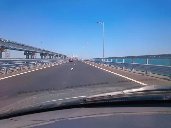 View through the windshield of a moving car. Crimea - June, 8, 2018: Travel on the Crimean bridge during its construction. View from the car